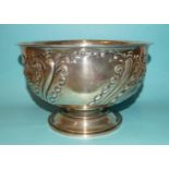 A late-Victorian silver pedestal bowl embossed with floral decoration, 23.5cm diameter, 15cm high,