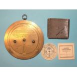 A brass table weather-forecasting calculator by Negretti & Zambra, consisting of three discs, the