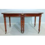 A George III mahogany D-end dining table, the top with pull-out action, on eight turned legs,