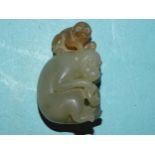 A jade figure of a monkey and juvenile grooming, 4cm high, 2.5cm wide.
