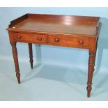 A 19th century mahogany wash stand, with galleried top above two frieze drawers, on turned legs,