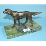 A brass model of a setter, on green onyx base, 20cm long, 14cm high.