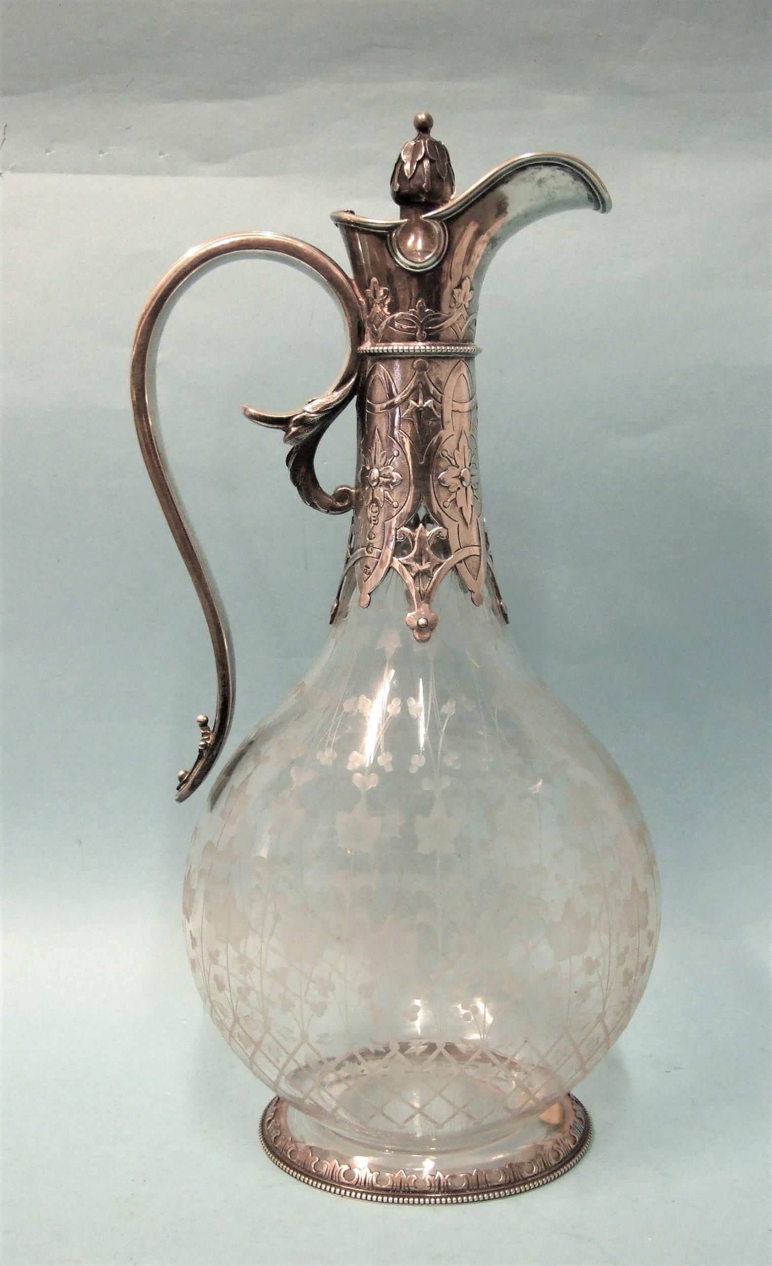 A good-quality Victorian silver-mounted claret jug of flattened bottle form, with all-over