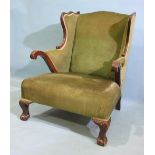 A Victorian mahogany shaped armchair on claw and ball front legs.