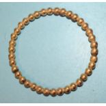 An unusual gold bangle of bead form, inner diameter 6.5cm, 12g.