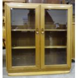 An Ercol freestanding bookcase, having a pair of glazed doors, 92 x 95cm.