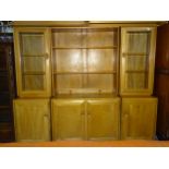 An Ercol sectional sideboard with shelves and cupboard above, 188 x 163cm.