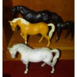 A collection of four Beswick horse ornaments: 'Black Beauty', 'Black Beauty Foal' and 2x 'Stocky Jog