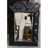 A carved oak wall mirror, 59 x 88cm.