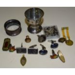 A silver egg cup, Birmingham 1920, a silver napkin ring and other items.