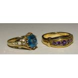 A 9ct gold ring set blue topaz, size N and another 9ct gold ring set five round-cut amethysts,