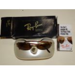 A pair of vintage Bausch & Lomb Ray-Ban sunglasses in case and outer packaging.