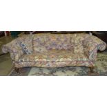 A 19th century Chesterfield settee, the low buttoned back and serpentine seat raised on short turned