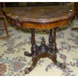 A Victorian walnut shaped fold-over card table on four columns and carved legs, 86 x 90cm opened.