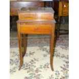 An Edwardian inlaid mahogany sewing box with lift lid, fitted interior and a frieze drawer, on