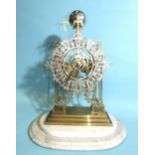 A 19th century brass skeleton clock, the frame of simple Gothic design surmounted by trefoils and