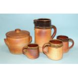 A group of Muchelney studio pottery: storage pot with lid, partially-glazed tall jug, tankard and