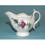 A small Worcester cream boat, 6.5cm high, with floral sprays.