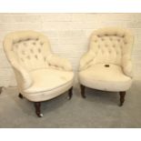 A pair of upholstered tub armchairs, each with buttoned back, on turned walnut front legs with brass