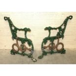 A pair of Coalbrookdale-style cast iron bench ends with dog's head terminals and serpent/grape