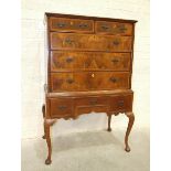 An early-18th century walnut chest of two small and three graduated drawers, on reconstructed