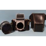 A Pentacon Six medium format SLR camera body, serial no.11623, in leather case, with Carl Zeiss Jena