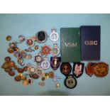 A collection of various badges, including a WWII Royal Naval Patrol Minesweeping Anti-Submarine