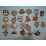 A collection of twenty-two various military badges, including Gloucestershire, The Wiltshire