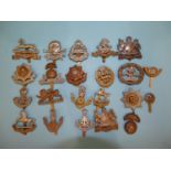 A collection of twenty-two various military badges, including East Lancashire, York & Lancaster,