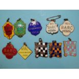 A collection of nine B.A.R.C. Goodwood enamel pendant members' badges: 1951 (843), 1953 (896),