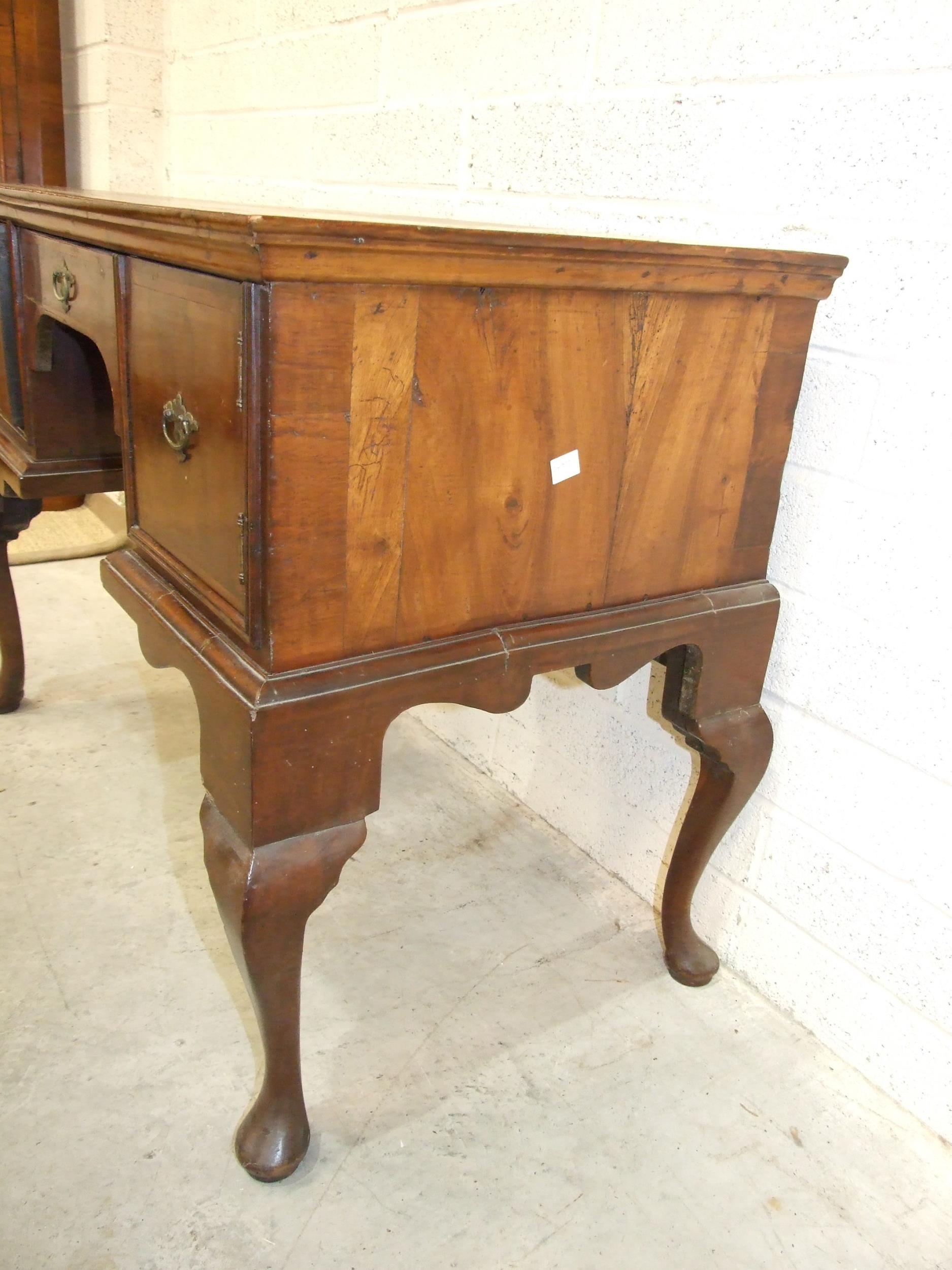 An 18th century walnut feather-banded lowboy, having a central drawer and two small cupboards, on - Image 3 of 4