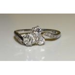 A diamond cross-over ring claw-set a cluster of three old brilliant-cut diamonds between 8/8-cut