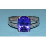 A Tanzanite and diamond ring claw-set an oval Tanzanite of approximately 3cts between split