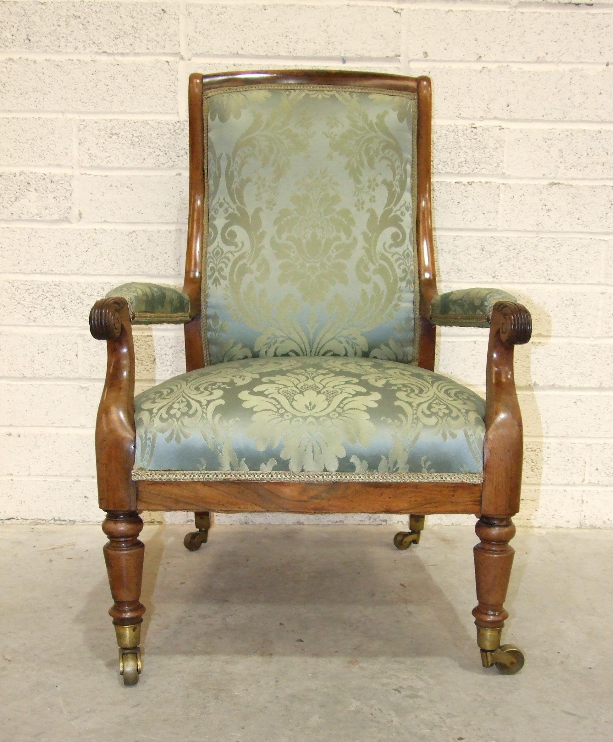 An early-19th century rosewood library chair, the curved back with upholstered centre to partially-