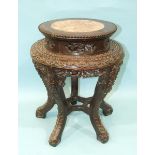 A Chinese carved hardwood plant stand with raised inset marble top, on five shaped and carved