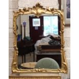 A gilt wood wall mirror with carved foliate frame enclosing the later mirror plate, 75 x 62cm, (