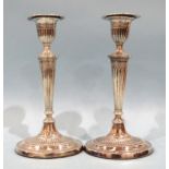 A pair of silver Adam-style candlesticks of tapered form, on oval bases, Fordham & Fordham,
