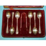A set of six silver teaspoons and tongs with raised decoration, Chester 1907, cased, (case broken).