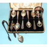 A set of six cased silver coffee spoons, Sheffield 1935, a silver napkin ring, a pair of sugar tongs