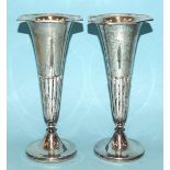 A pair of George V silver spill vases, having an octagonal top above tapering half-gadrooned column,