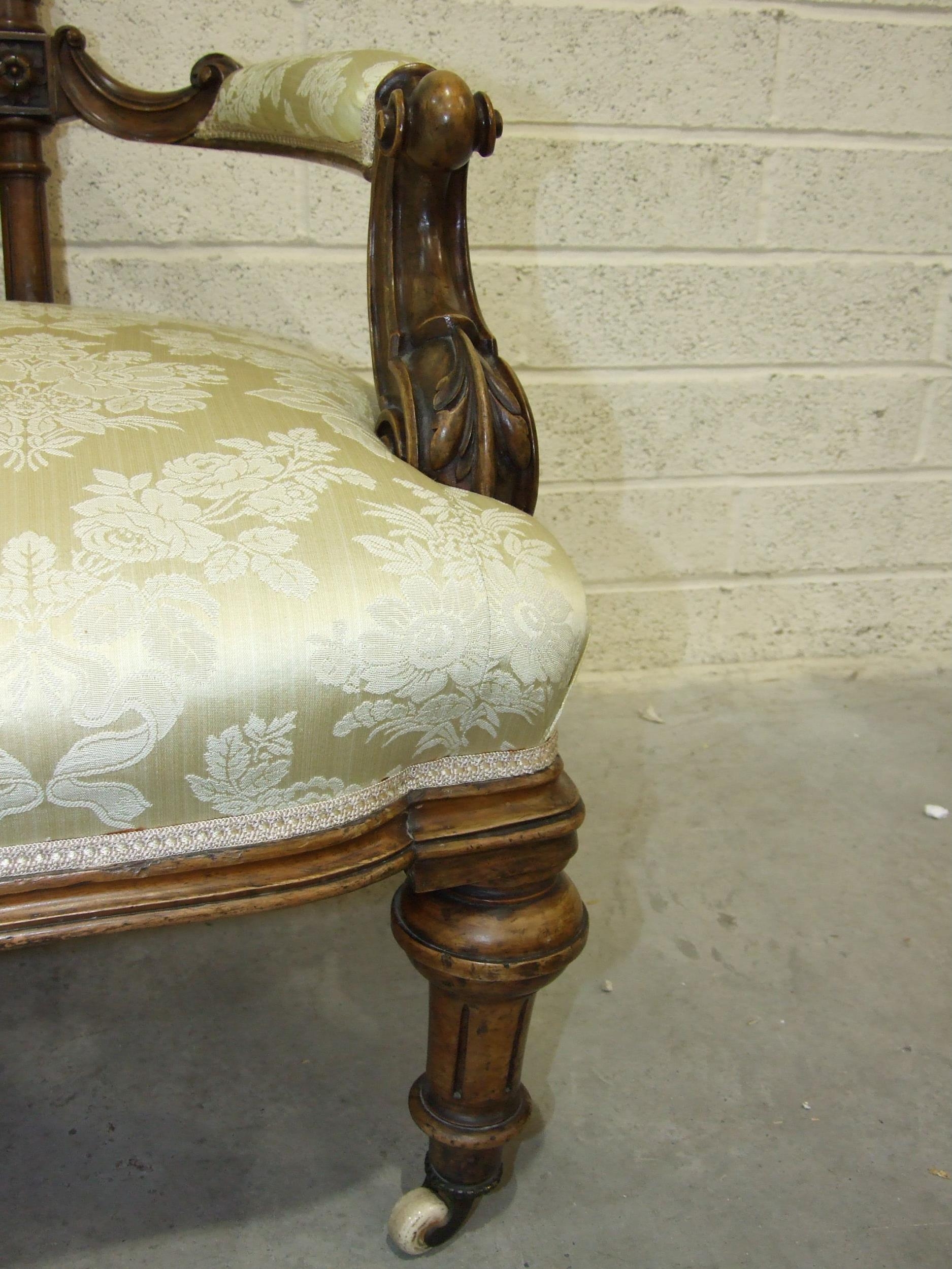 A late-Victorian walnut drawing room settee, the carved and upholstered back to scroll open arms and - Image 2 of 3