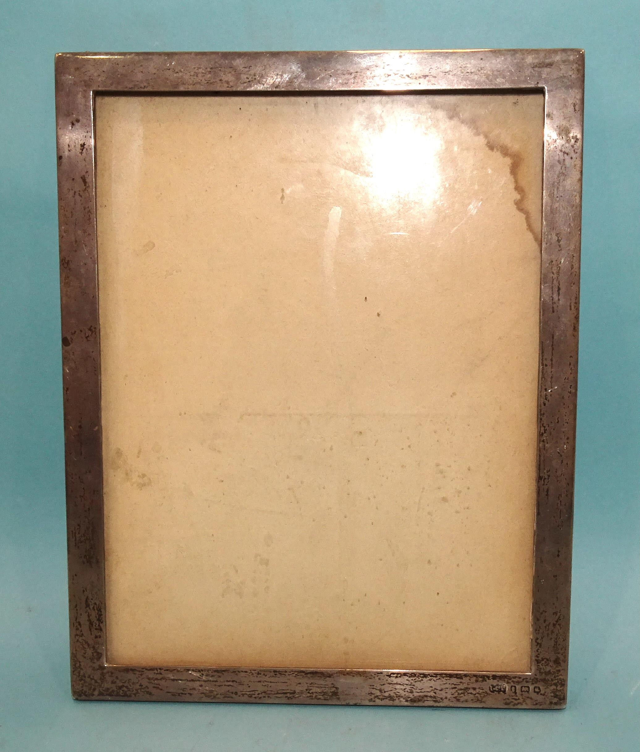A silver rectangular photograph frame of plain form, 23 x 18cm, (marks rubbed).