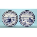 A pair of Continental large blue and white wall-hanging chargers depicting coastal fishing boats