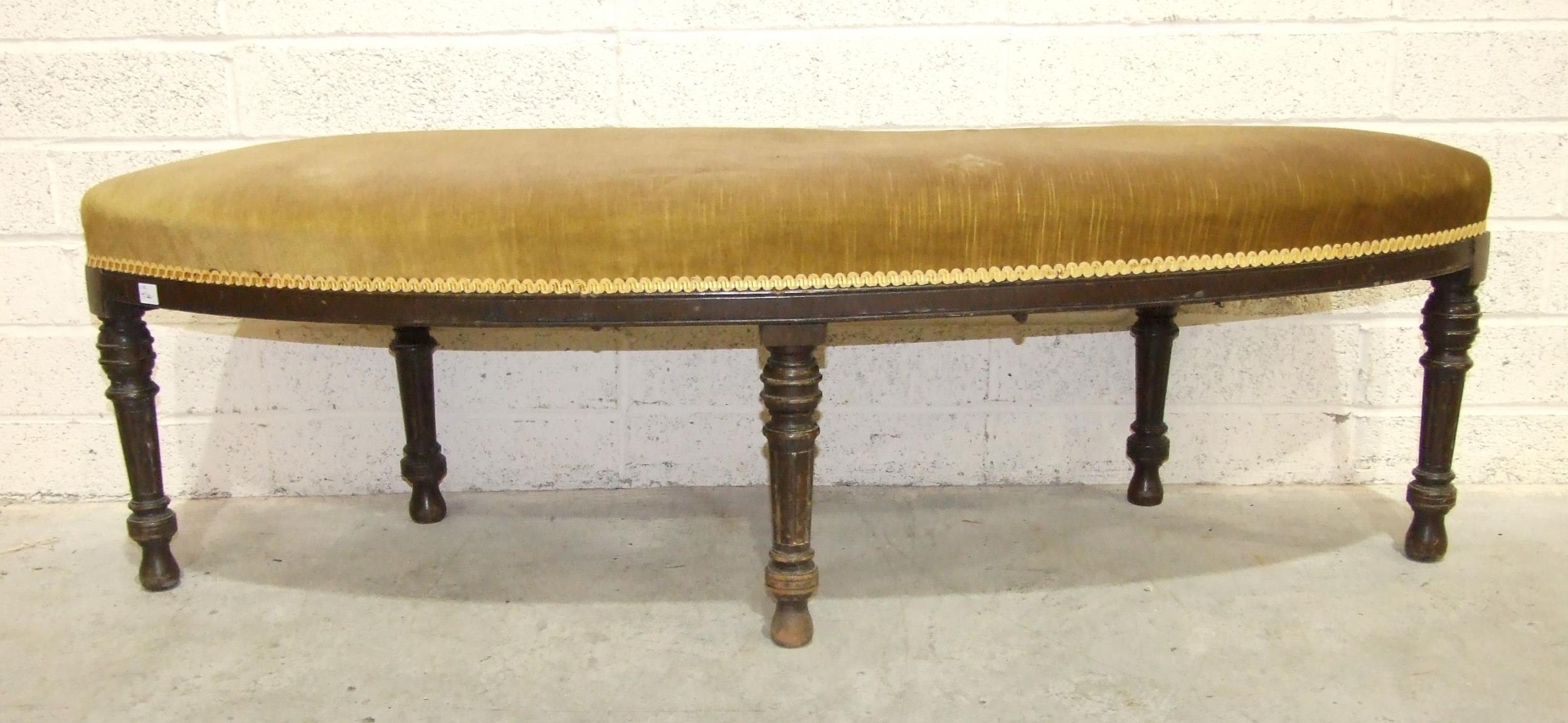 A late-Victorian stained hardwood alcove/window seat with slightly-curved upholstered seat, on