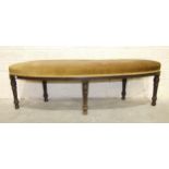 A late-Victorian stained hardwood alcove/window seat with slightly-curved upholstered seat, on