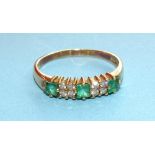 An 18ct gold ring set three square-cut emeralds with two clusters of four diamond points, size S,