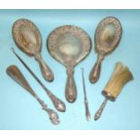 A Walker & Hall silver-backed hand mirror and two matching hair brushes, London 1911?, together with