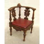 A stained hardwood Continental corner chair, the curved back with central cherub's head on griffon-
