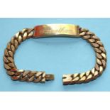 A 9ct gold curb-link identity bracelet with concealed clasp, 21cm, 63.7g.