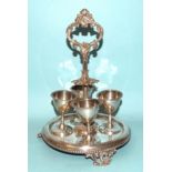 A Victorian silver egg cup stand with cast handle and beaded rims to the base and four egg cups,